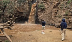 Tourist watching a waterfall in Hell's Gate National Park